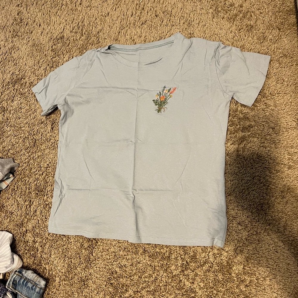 Blue T shirt with a flower